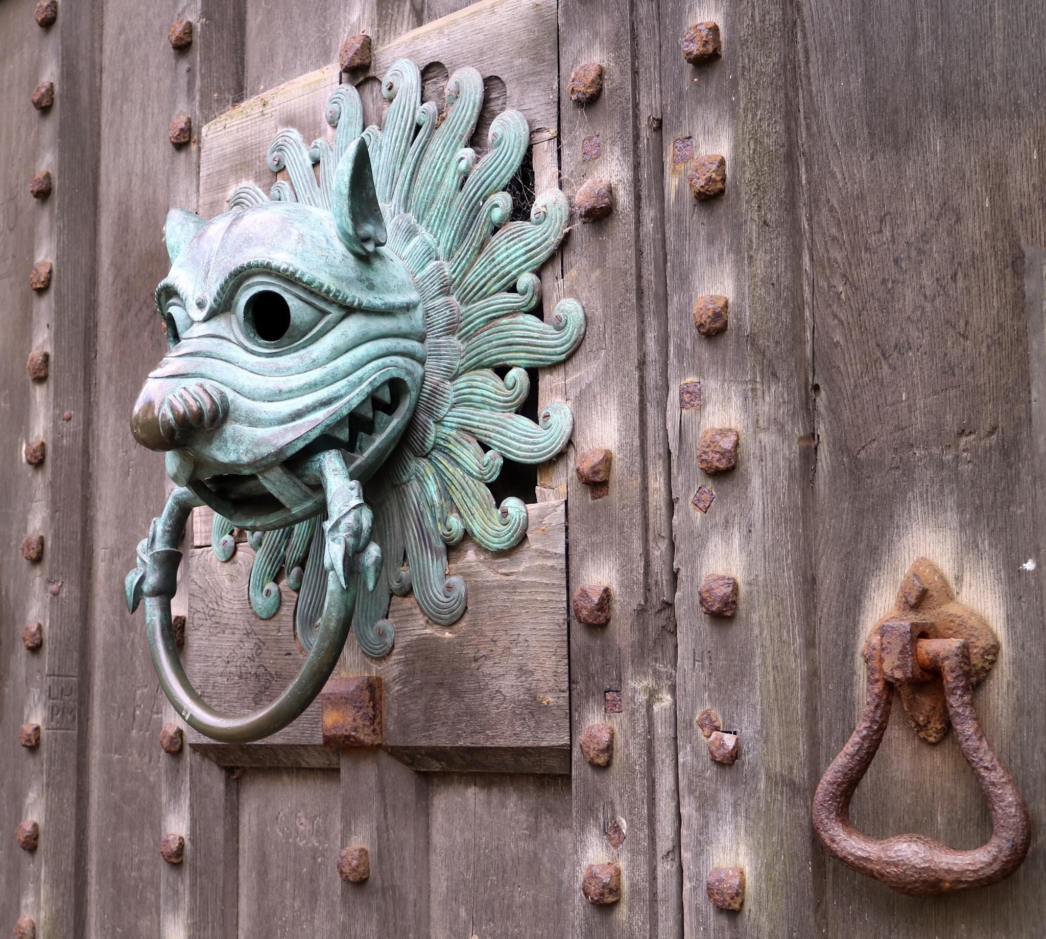 Knocker on door with sanctuary ring