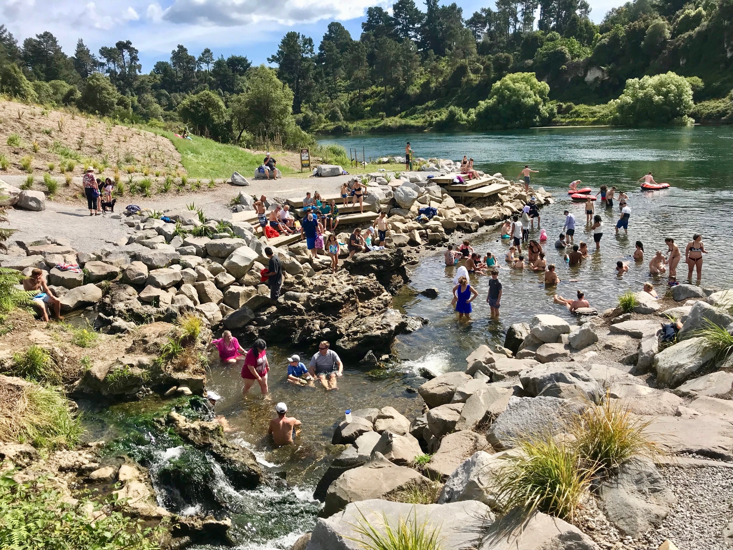 People gather at a hot spot in the Waikato river.  Because of the geothermal activity in this area, this area of the lake is like a hot tub. #waikatoriver #geothermal #nature #newzealand #taupo #hotspot