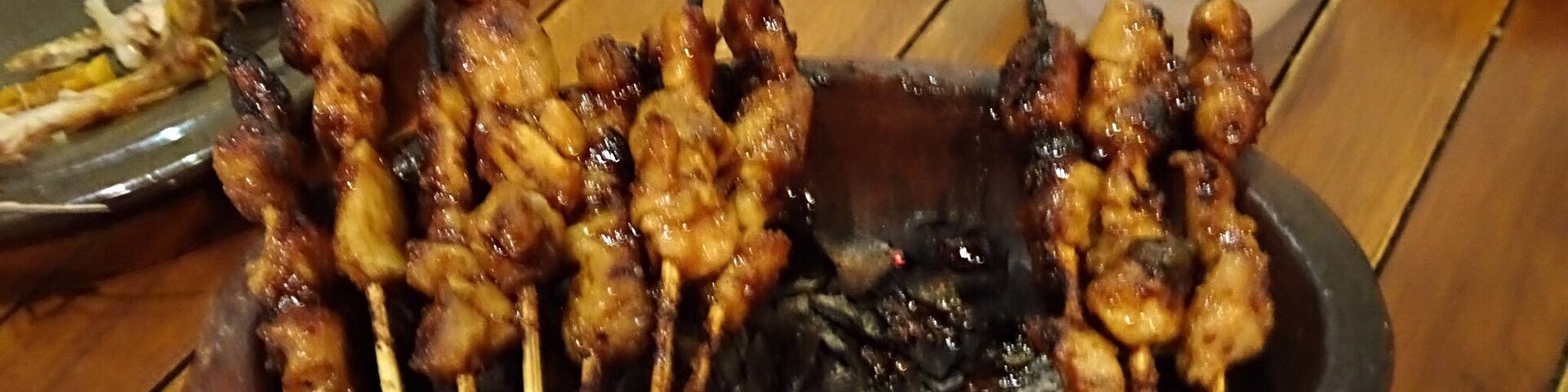 Barbecued meat or Satay is served over burning charcoal here in Bandung.