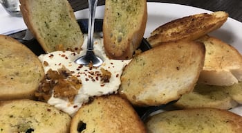 Baked goat cheese with dried apricots, walnuts, and garlic bread #Yum