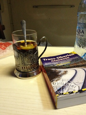 We took the Trans-Siberian train from Moscow to St Petersburg, 8 hours ride in 3rd class (platzkart) and we didn't regret it at all. We slept very well, the provodnitsa was really kind, but don't expect to find a lot of English speakers there. Body language does wonders :).
This is the cup they use for serving tea, i especially liked the metal cup holder, which was beautifully crafted. You can also buy one from the train, I think it was around 800 RUB. And it seemed only appropriate to read the Trans-Siberian Handbook on the way. Dreaming of doing the whole thing from Moscow to Vladivostok one day!