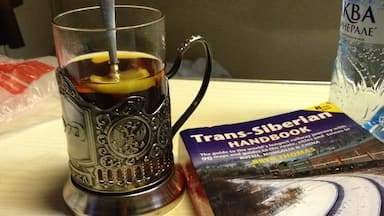 We took the Trans-Siberian train from Moscow to St Petersburg, 8 hours ride in 3rd class (platzkart) and we didn't regret it at all. We slept very well, the provodnitsa was really kind, but don't expect to find a lot of English speakers there. Body language does wonders :). 

This is the cup they use for serving tea, i especially liked the metal cup holder, which was beautifully crafted. You can also buy one from the train, I think it was around 800 RUB. And it seemed only appropriate to read the Trans-Siberian Handbook on the way. Dreaming of doing the whole thing from Moscow to Vladivostok one day!