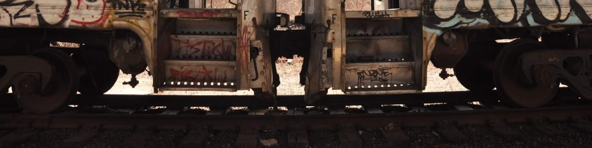 Abandoned train cars on the tracks under I-93 between Community and Sullivan Stations on the Orange line.  You may recognize them from 'The Town'!  Bit of a creepy walk to get to them.
