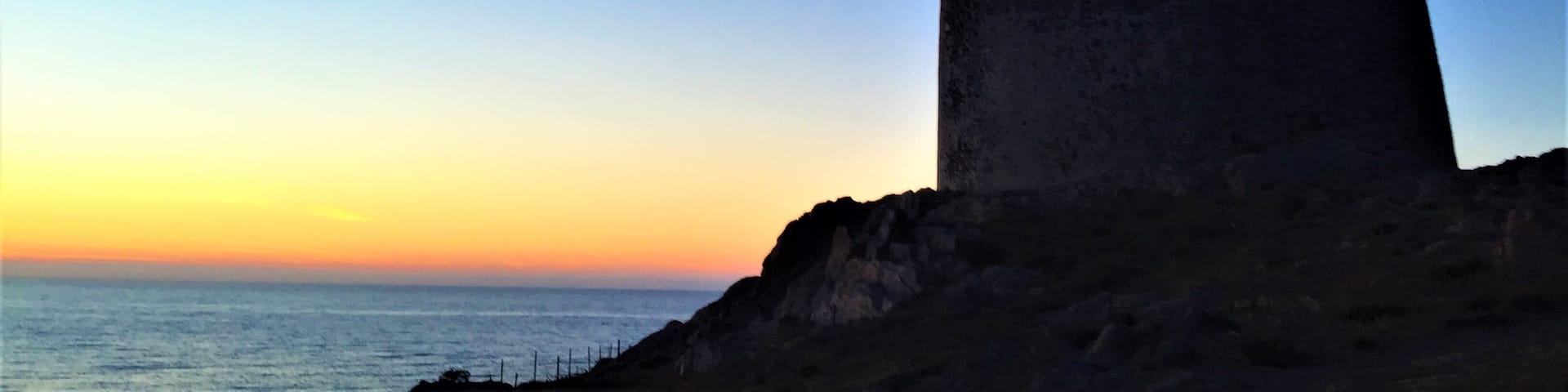 The old tower as he sun sets in Isola Rossa