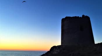 The old tower as he sun sets in Isola Rossa