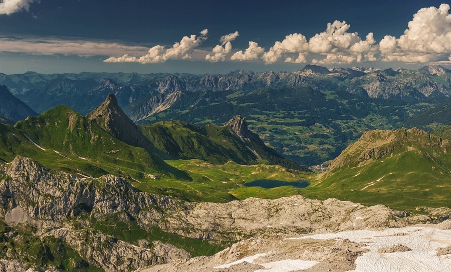 July 2016
Raetikon view from Wissplatte, Voralberg, Austria
Wissplatte with altitude 2.628 meters is an accessible summit in the Raetikon mountains just on the border of Austria and Switzerland. You can get there in ca. 1,5-2 hours from Tilisuna Huette or in ca. 6- 7 hours from Tschaggung in the Montafon valley.
In the view you can see the prominent spike-like peak of Schwarzhorn (2.460 m), Tilisuna Huette cabin (2.208 m altitude, just below the Schwarzhorn) and Tschaggungser Mittagspitze (2.160 m). Close to the hut you can see the Tilisuna see mountain lake (2.103 meters) under the Tilisuna Seehorn (2.342 m). The valley in the background is the Montafon valley (around 700 m alt.) with villages Vandans and Tschaggung. In the background you see the ranges of Lechquellengebirge (up to 2.700 m) and Verwallgruppe (up to 3.000 m).
On a sunny day it is just a rewarding view after the daily hike from the valley of Montafon.