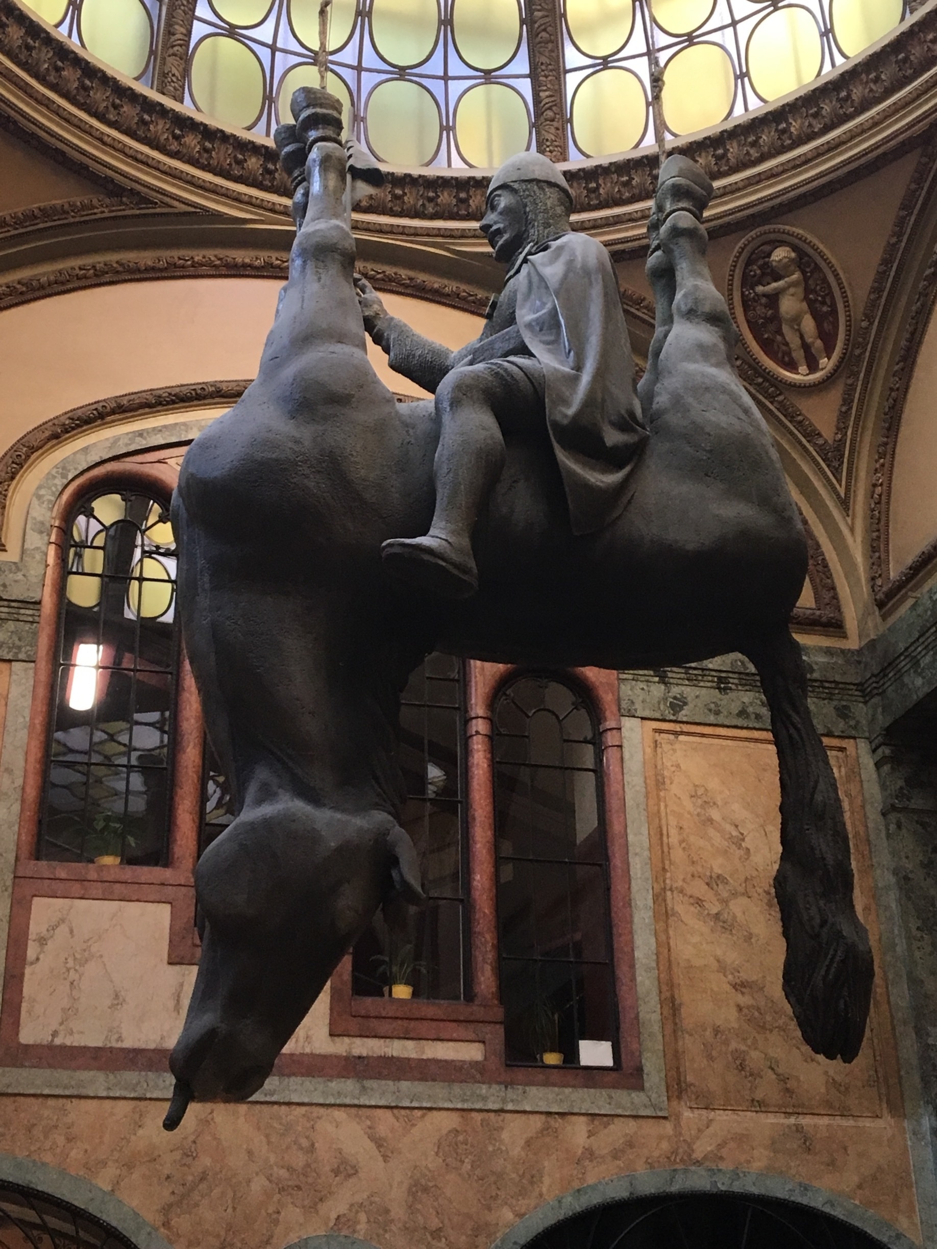Unusual David Cerny sculpture inside the Lucerne shopping arcade. King Wenceslas astride an upside down horse.