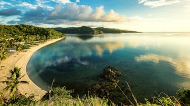 Woke up for this magnificent early morning view overlooking Aglicay Beach in Alcantara, Romblon, Philippines. The sun was just rising from the east and cast the scene in soft, warm colors; the clear and calm sea reflecting the clouds and the blue of the sky.