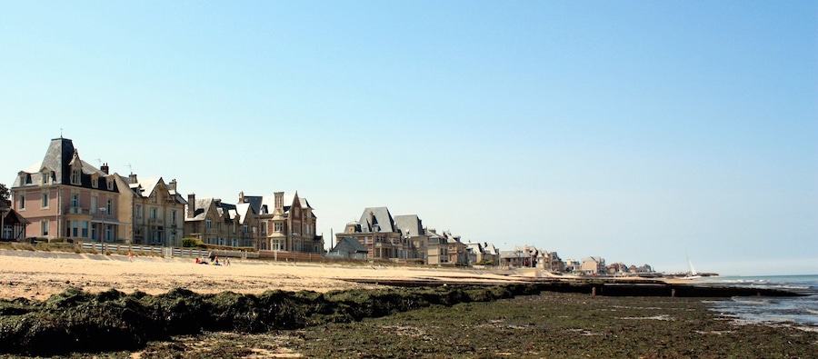 The Normandy beach with some old houses .