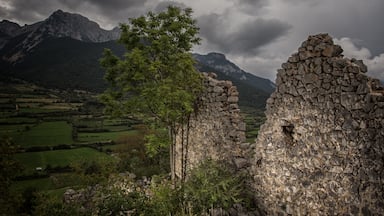 Castle ruins above Gósol, Spain. Outdoor sports attractions abound. The Pedraforca towers over the community in the background, a huge monolith and summit destination