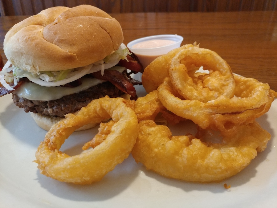 BeeBops Grill was an unexpected find after spending the day hiking in the outskirts of Ohio's Amish country.
I was in the mood for a burger and would have settled on anything that wasn't a chain. I was lucky enough to stumble upon BeeBops.
I got a 1/2lb bacon cheeseburger. The burger came topped with provolone AND there was even more provolone stuffed inside the burger! The accompanying onion rings were huge, crispy and crunchy. I only got a half order, but the fat kid inside me was pining for more! As a guy who normally skips condiments, I was won over by the horseradish heavy dipping sauce.
As a side note, I saw numerous patrons ordering the daily special. It was a mountainous twin peaked plate of the aforementioned onion rings and lightly fried fish fillets.
If you find yourself hungry and in Wilmot, skip past the numerous Amish buffets and give BeeBop's a shot.