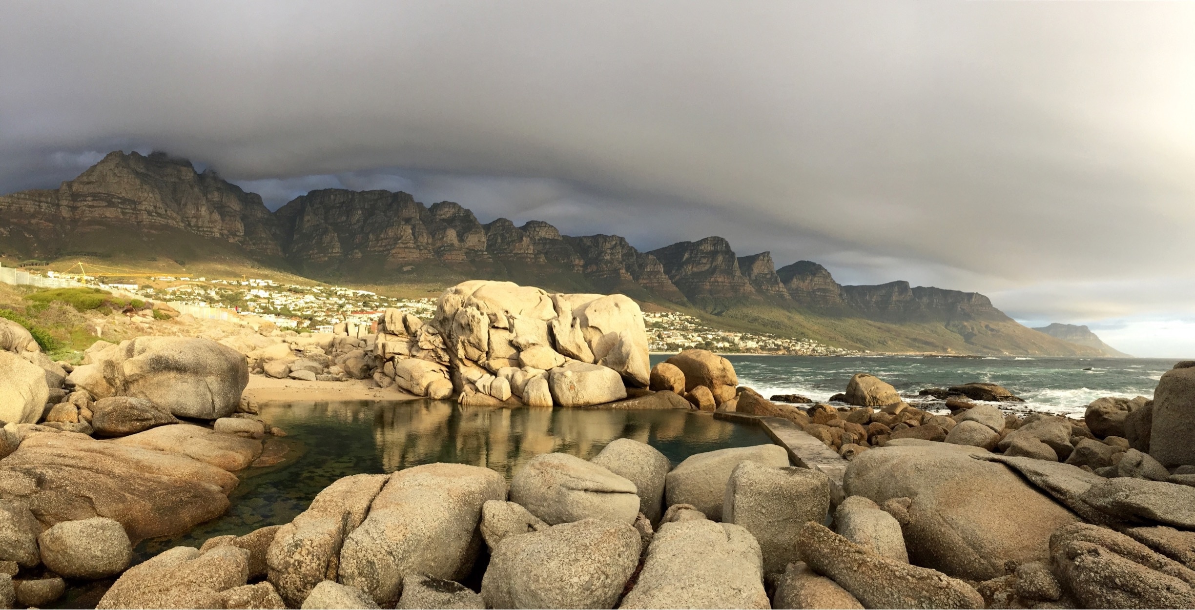 This tidal pool at the north end of Camps Bay main beach is the perfect spot to watch the sun sink while the "Table Cloth" rolls over Table Mountain National Park #GoldenHour #CampsBay #SouthAfrica #CapeTown