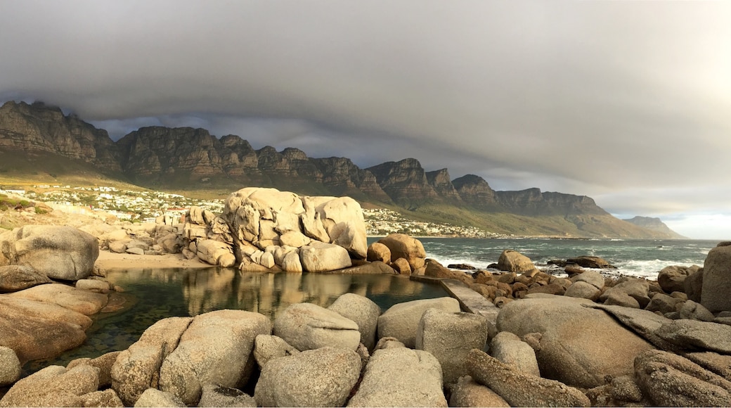 This tidal pool at the north end of Camps Bay main beach is the perfect spot to watch the sun sink while the "Table Cloth" rolls over Table Mountain National Park #GoldenHour #CampsBay #SouthAfrica #CapeTown