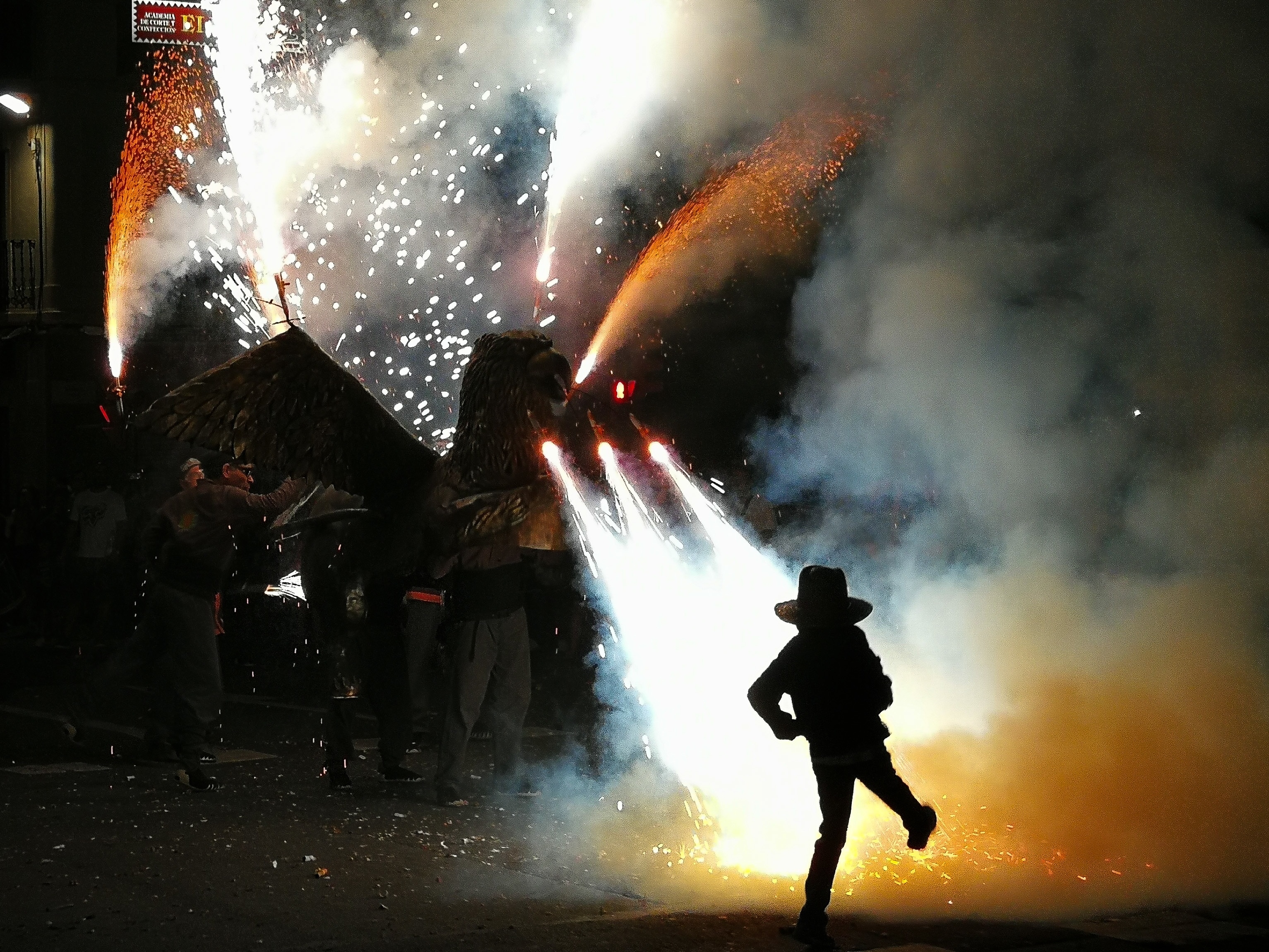 A little boy dares the fire while dancing in front of a dragon of fireworks in Tarragona following the popular tradition of Correfocs (fire runners) for Sant Joan's Day #culture