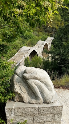 My husband and I traveled through Greece by motorcycle, and we explored different historic sites. This region in Greece has a series of stone bridges that were built during the Ottoman Empire! This is an unique one because has three arches.