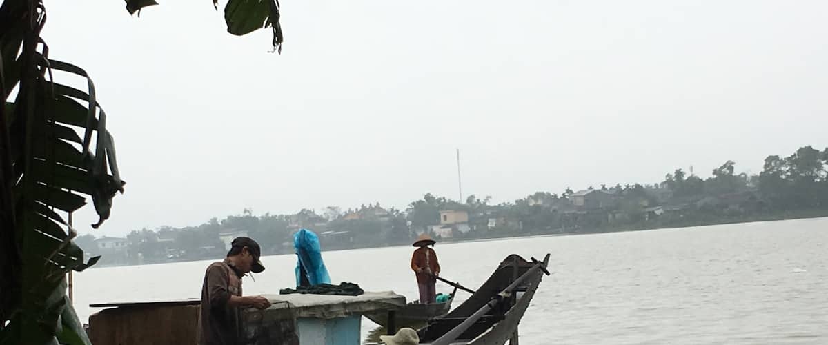 Villagers of Sinh Village washing their fishing nets