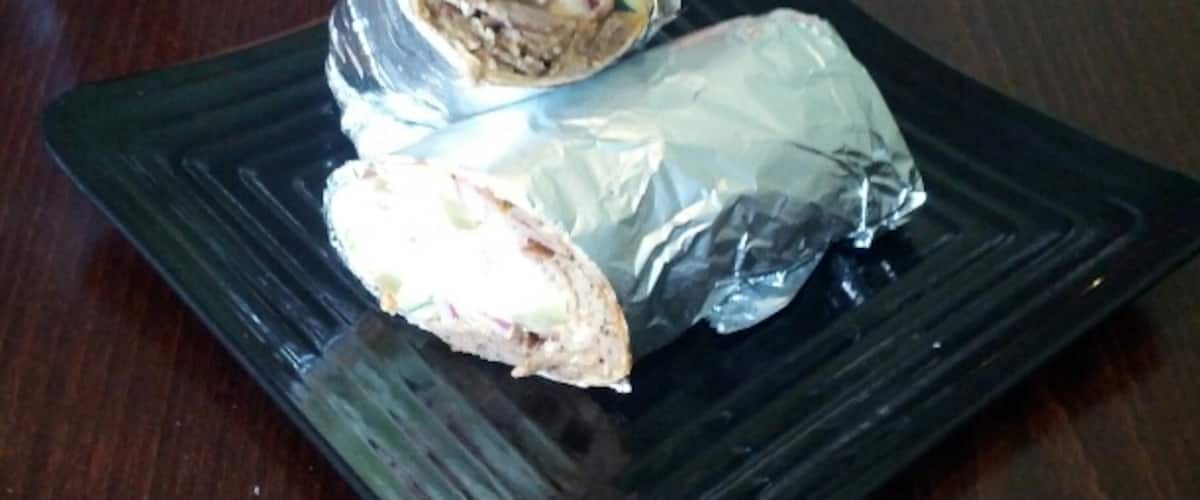 A wrap with gyro meat, lettuce, onions, cucumbers, pickles, feta cheese and kalamata olives from Mezze Middle'Terranean (Middle Eastern and Mediterranean food, get it?...)