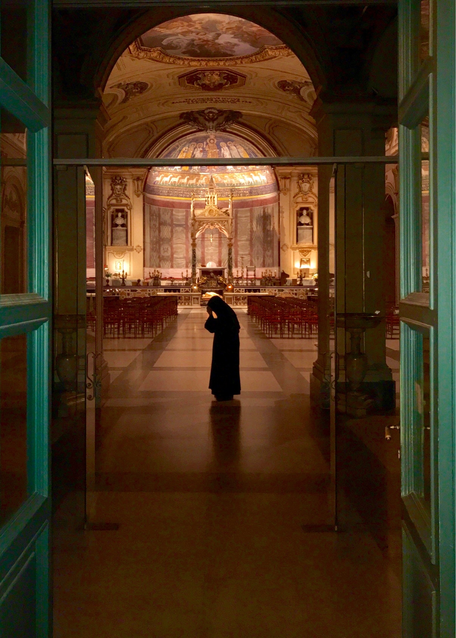 A nun blesses herself before closing the church for the evening. 
