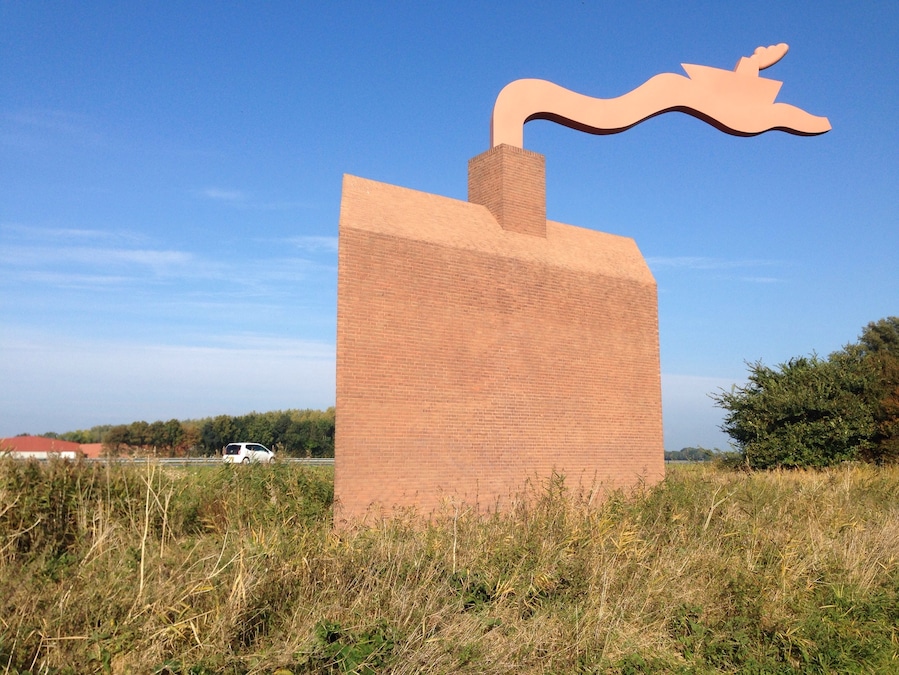 This "Monument Noordoostpolder" is a kind reminder to highway motorists about how much below sea level they are actually -safely- driving. The wave from the chimney also serves as a weather vane. - the ship is going against the currents and the wind.
Making land where the sea once was, is not supposed to be easy. #highway-art
http://www.flevolanderfgoed.nl/home/kunst/noordoostpolder/nagele/monument-noordoostpolder.html
