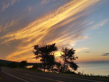 value: "Staying at the AmericInn was awesome because this sunset happened right in the backyard! We raced through the porcupine mountains to catch the sun dipping under the horizon. At 9:20pm too! "
