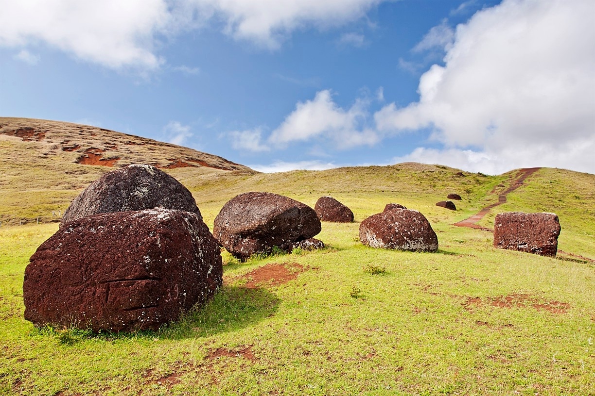 You may have noticed that some of the moai sport a red crown, known as a pukao. It's believed that these giant stones, which weigh up to 11 tons, may have represented a hair style or headdress popular among the natives. They were carved from an iron rich scoria stone at the Puna Pau quarry, rolled to their assigned moai, and then (somehow) balanced atop the moai's head.  A recessed notch, matched to the moai's head, made the balancing act more manageable and ensured that the crown stayed put.