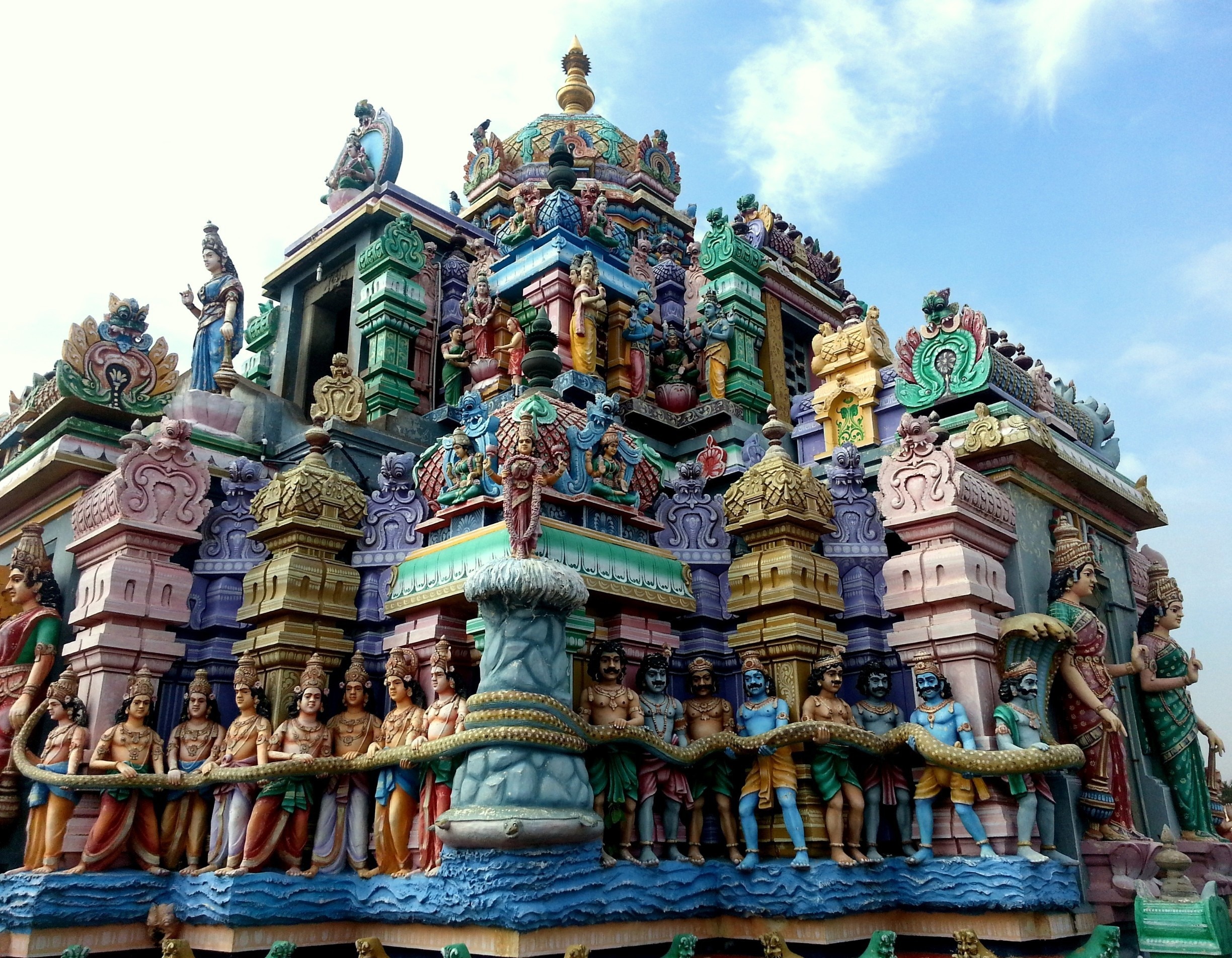The beautiful 'gopuram' (tower) of the Ashtalakshmi Temple in Chennai, India.

Indian Hindu Gods and Goddesses meticulously sculpted. Note the large snake which they are holding across them.

read more on my blog
https://theredbagandpurpleshoes.wordpress.com/2015/01/14/iconic-temples-of-chennai/