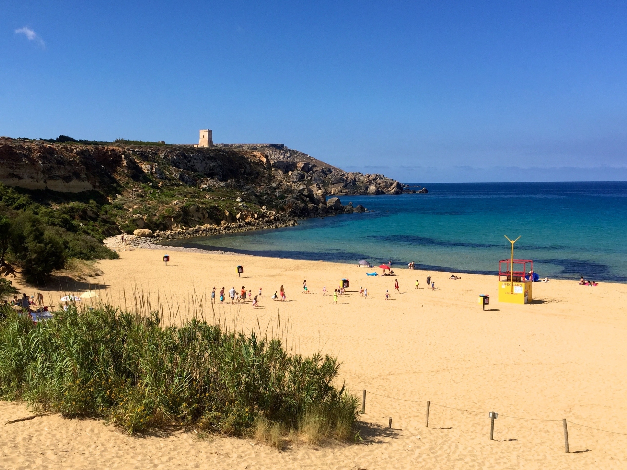 Golden Bay is one of the few sand beaches on the north-west coast of Malta. It was previously known as Military Bay. The white beach slopes gently allowing swimmers to easily walk into the sea. In summer months, there are lifeguards on duty. Golden Bay is the most popular tourist beach of the Manikata region.