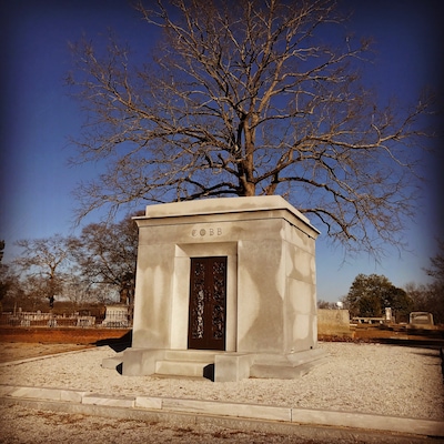 Burial site of Tyrus (Ty) Raymond Cobb in his home town of Royston, Georgia. Ty Cobb is widely regarded as one of, if not the best, baseball player of all time.
Nicknamed The Georgia Peach, Cobb was an American Major League Baseball outfielder. He was born in rural Narrows, Georgia. Cobb spent 22 seasons with the Detroit Tigers, the last six as the team's player-manager, and finished his career with the Philadelphia Athletics. In 1936 Cobb received the most votes of any player on the inaugural Baseball Hall of Fame ballot, receiving 222 out of a possible 226 votes (98.2%); no other player received a higher percentage of votes until 1992. In 1999, editors at the Sporting News ranked Ty Cobb 3rd on their list of "Baseball's 100 Greatest Players".
Cobb is widely credited with setting 90 MLB records during his career. He still holds several records as of the end of the 2016 season, including the highest career batting average .367 and most career batting titles with 12. He retained many other records for almost a half century or more, including most career hits until 1985 with 4,191, most career runs with 2,246 until 2001, most career games played (3,035) and at bats (11,434) until 1974, and the modern record for most career stolen bases (892) until 1977. He still holds the career record for stealing home (54 times) and for stealing second base, third base, and home in succession (5 times), and as the youngest player ever to compile 4,000 hits and score 2,000 runs. Cobb ranks fifth all-time in number of games played and committed 271 errors, the most by any American League (AL) outfielder.