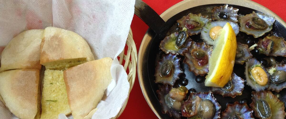 Two plates you can taste when you are visiting Madeira Island! “Lapas” and “bolo do caco” with garlic butter !!