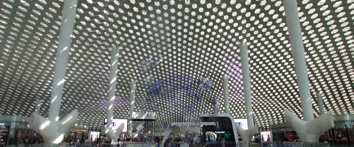 Recently completed Terminal 3 of the Shenzhen Bao'an International Airport.
Hexagonal-shaped skylights flood the terminal with natural light, and the stylized "tree" columns are actually disguised air-conditioning vents.  A 3-story wire butterfly sculpture located on the ground floor cycles through various colors of LED lights which are reflected on the ceiling.  Polished tile floors and lots of glass and stainless steel reflect the honeycomb motifs, lending a futuristic vibe to the entire space.
#china #shenzhen #architecture
