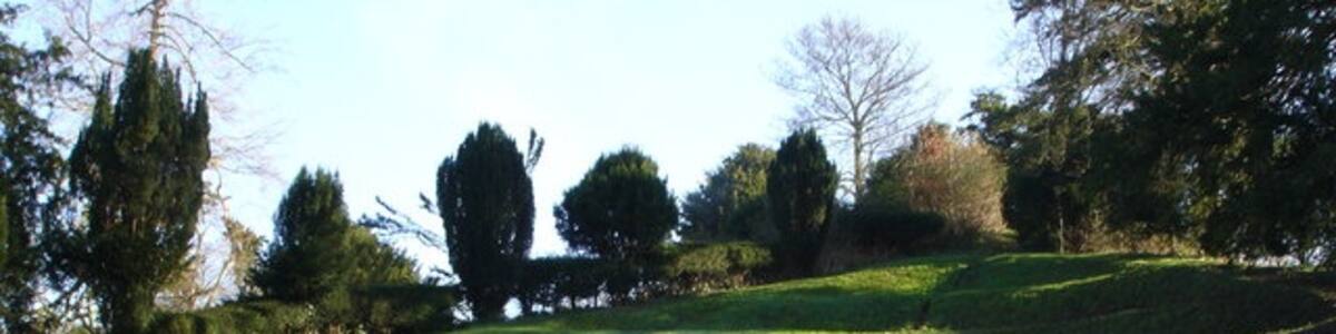 Photo "Earthworks - Moot Gardens, Downton The Moot is a Grade 1 listed 18th century ornamental garden reputed to have been a Saxon meeting place. Left for many years to its own devices, it became overgrown and unrecognisable until a group of volunteers decided to do something about it. Now, it is possible to walk through the gardens down to the River Avon or visit the lake and amphitheatre, which in the summer is often used for open-air plays and concerts." by Judith Green (Creative Commons Attribution-Share Alike 2.0) / Cropped from original