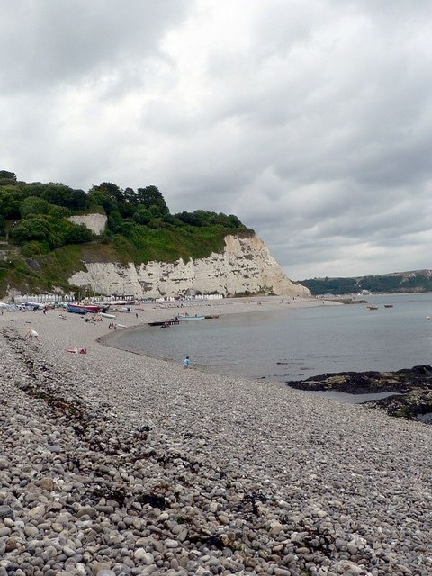 South-west end of the beach at Beer. With the tide flooding and filling the rockpools on the right. White Cliff and East Ebb at the far end of the beach, and Seaton Bay beyond them.
