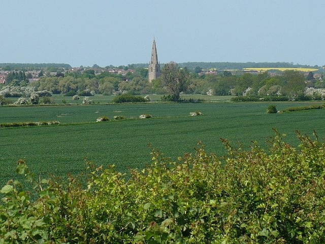 View towards Olney A view from a minor road, which is part of the Three Shires Way, towards Olney with the prominent spire of the church of St Peter and St Paul.