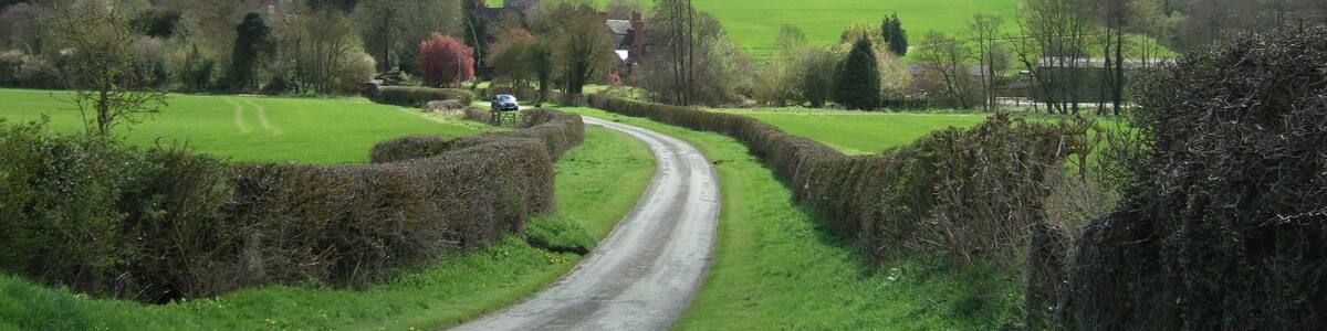 Photo "The tiny village of Eaton, with Wenlock Edge behind." by Dpaajones (page does not exist) (Creative Commons Attribution-Share Alike 3.0) / Cropped from original