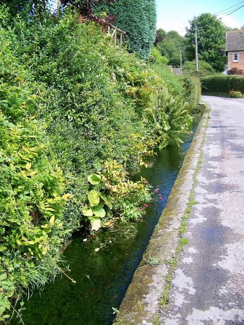 Roadside stream, Iwerne Minster Iwerne is an ancient British (Celtic) river-name, first recorded as Iwern broc in the mid-10th century but much older than that, probably meaning 'yew-tree stream'. Iwerne Minster is recorded as Evneminstre in the Domesday Book of 1086, but its first appearance is in a Saxon charter dated 871 where it is simply ywern or hywerna. The affix is Old English mynster '(church of) a monastery' with reference to the early possession of this estate by Shaftesbury Abbey.