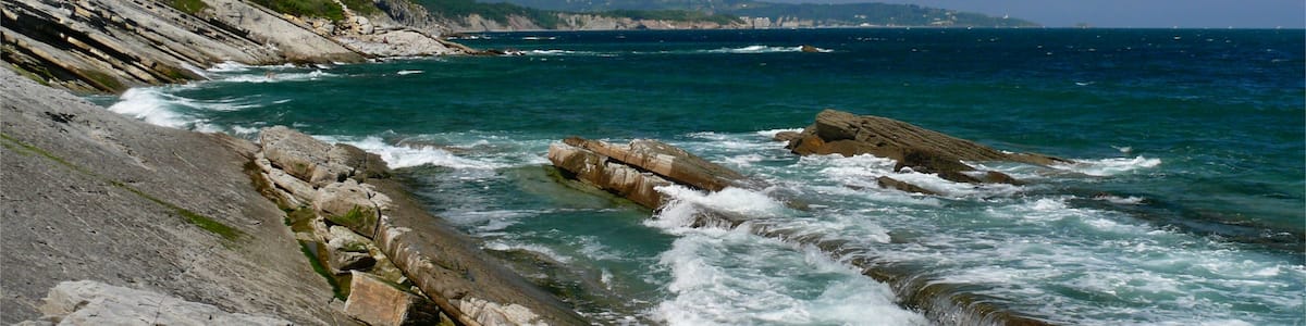 Photo "The basque rocky coast at the south of Urrugne, Pyrénées-Atlantiques, Aquitaine, Basque Country, France, June 2009." by dynamosquito (Creative Commons Attribution-Share Alike 2.0) / Cropped from original
