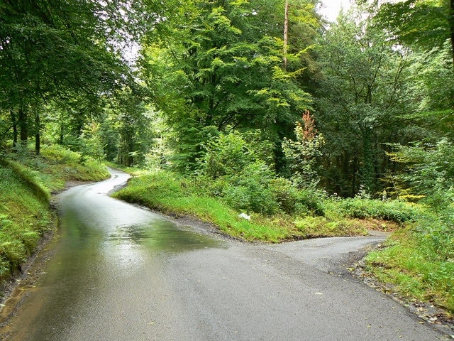 Lane junction Lane junction in Llantrisant Forest. The road is wet with running water coming of the hills after heavy rain.