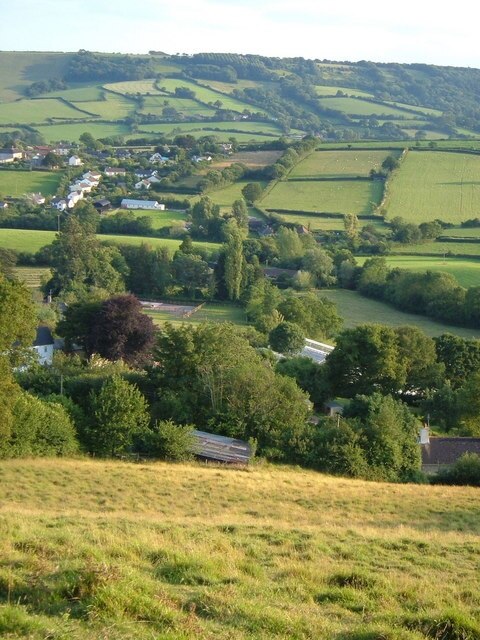 Northleigh from the northeast. From the top of the lane where a footpath joins it near Northleigh Cross, looking down across the village and the valleys that lead to the River Coly, towards Strap Common.