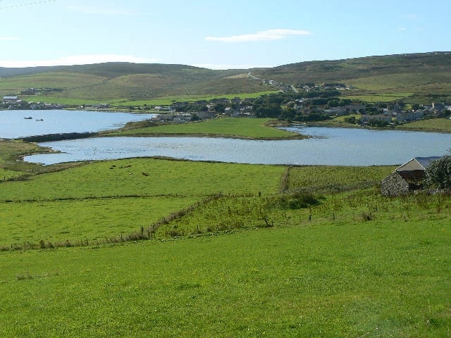 View of Finstown from HY3615. Down over farmland to The Ouse and then beyond to Finstown itself.