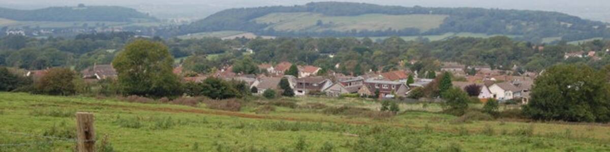 Photo "Pasture near Shipham, Mendips Looking north over Shipham to Dolebury Warren." by Clive Perrin (Creative Commons Attribution-Share Alike 2.0) / Cropped from original