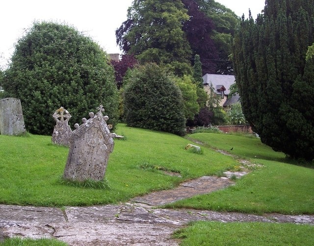 Churchyard, St John the Baptist, Buckhorn Weston The church is situated on a hillside and the subsidence damage is clearly visible.