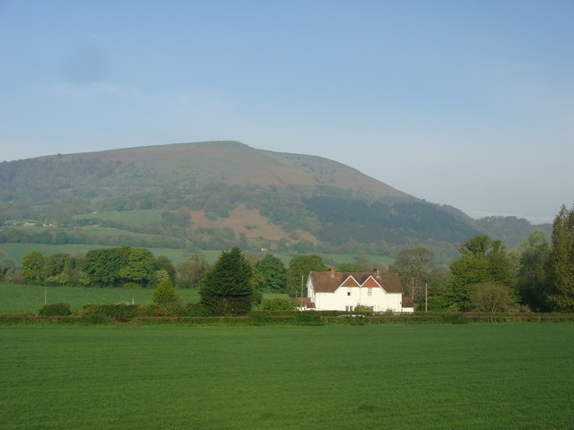 A pair of houses, and Blorenge I'm taking this to be a pair of semi-detached houses rather than one residence (and happy to be corrected if wrong), in splendid isolation under the massive gaze of Blorenge. The photo was taken from a train.