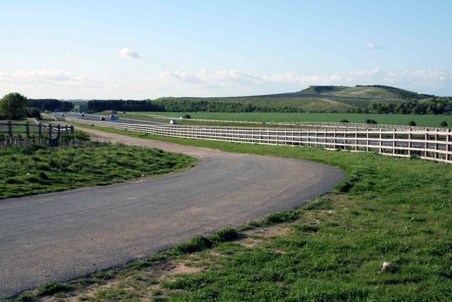 Looking north Behind the fence is the link road to the A1M , which can be seen in the distance. The old roundabout has gone thank goodness and been replaced by a bridge over the A1. In the distance is the spoil heap of Harworth Coal Mine currently mothballed.