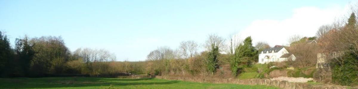 Photo "Wells Brook meadows Buckcastle Hill rises to the right." by Jonathan Billinger (Creative Commons Attribution-Share Alike 2.0) / Cropped from original