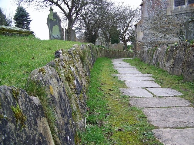 Gravestones at St Peter's Church, Great Cheverell Ancient gravestones line the path to the church porch.