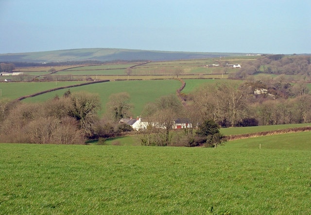 Meadow at Churchland Farm The farmhouse is in the centre. The hill on the horizon is Mynydd Ysgubor.