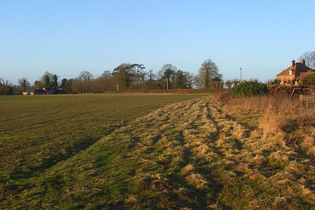 Farmland, Elcot A cereal field with the farmhouse to the right and buildings near the hotel to the left.