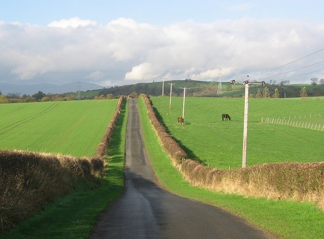 Pitdinnie Road. View north with the Ochil Hills in the background.