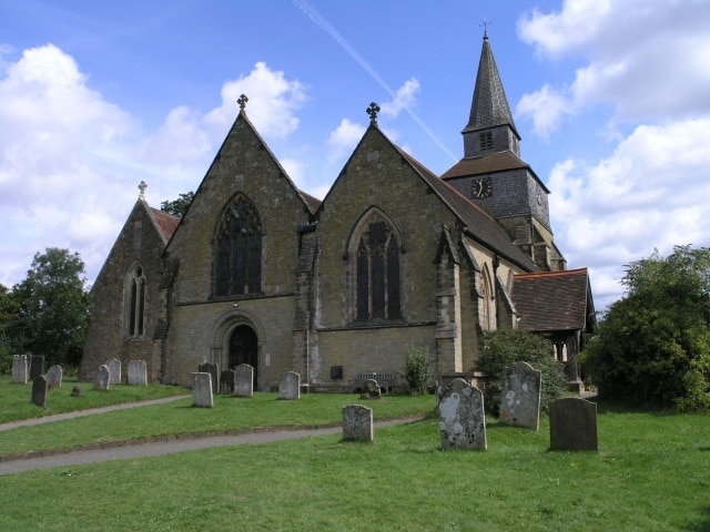 St. Nicholas Church, Godstone. Built on the location of a Norman church, the current building dates back to the early 13th century. The tower was added later in that century, but was faced with stone as late as 1872. Further modifications have since been made and the church has six bells.