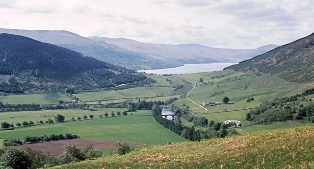 View from above Fortingal The view south from the hillside above Fortingal, with the triple arch bridge over the River Lyon near the picture centre, and Loch tay in the distance.